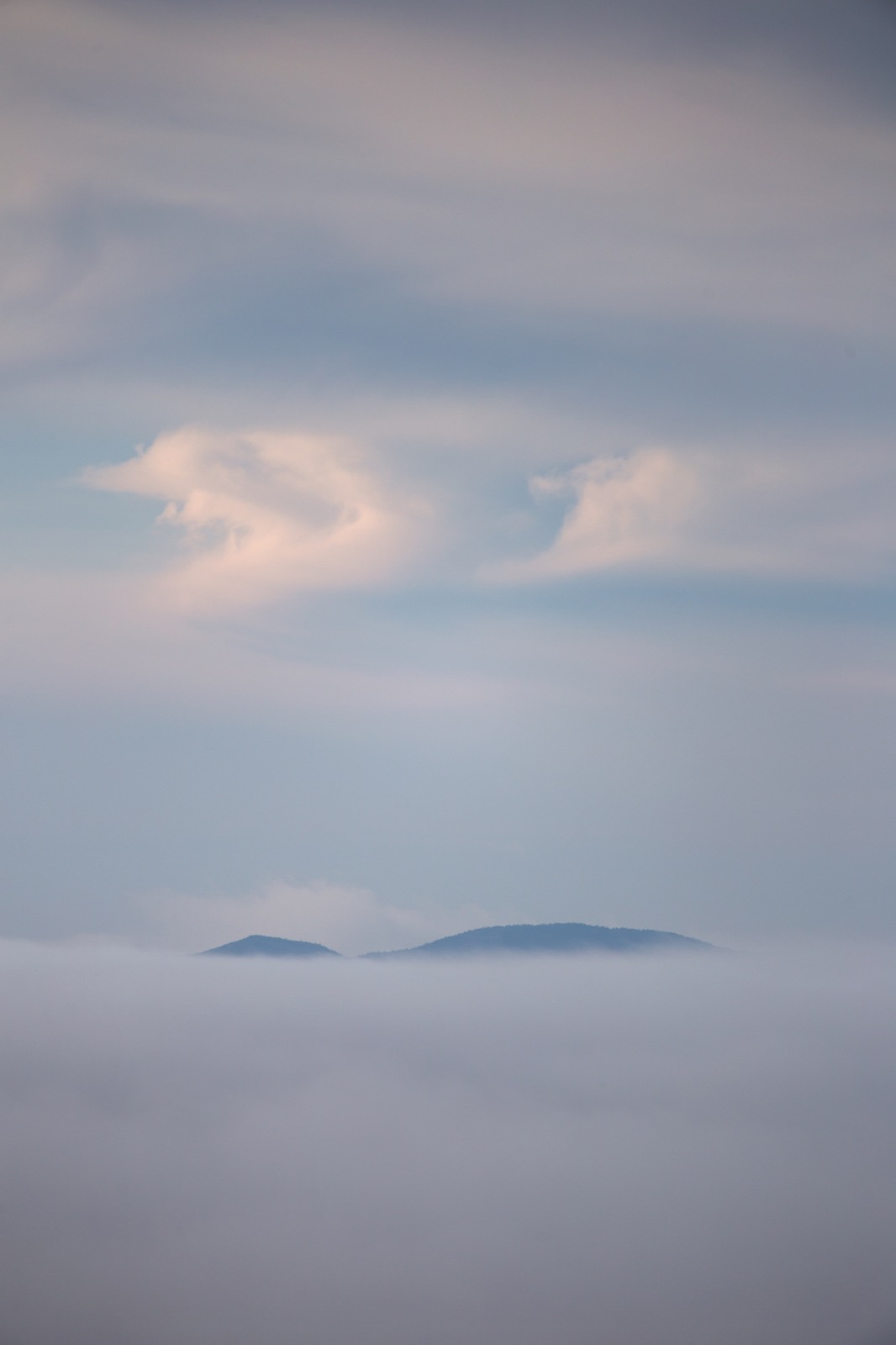 Mountaintop Peeking Over Thick Cloud Cover