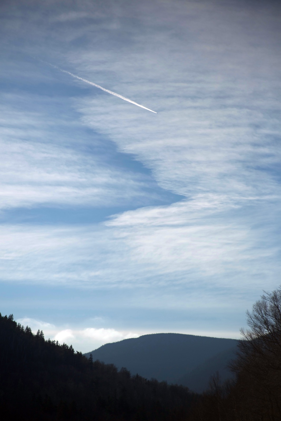 Jet Trail Across a Cloudy Sky