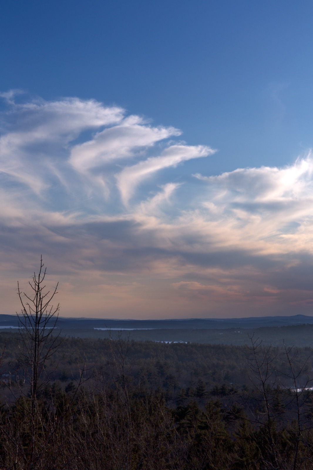 Curling Clouds Over Dim Landscape