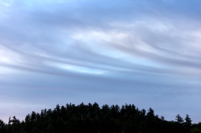 Swirling Clouds Over Hill