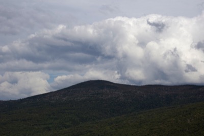 Forested Mountains Under Clouds