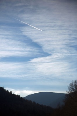 Jet Trail Across a Cloudy Sky