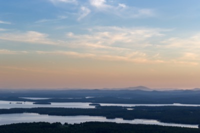 Hazy Sunset Over Lakes and Mountains