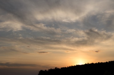 Glowing Clouds Over Silhouetted Hill